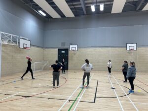 Teachers learning netball in CPD session in Moray
